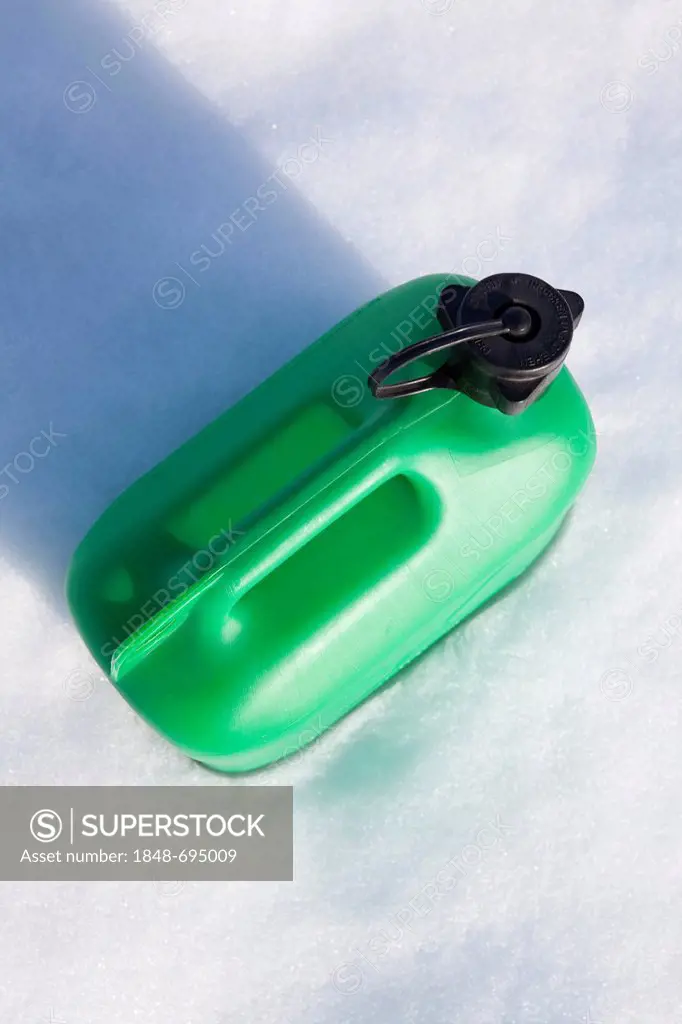 Green petrol canister in the snow, winter, energy consumption