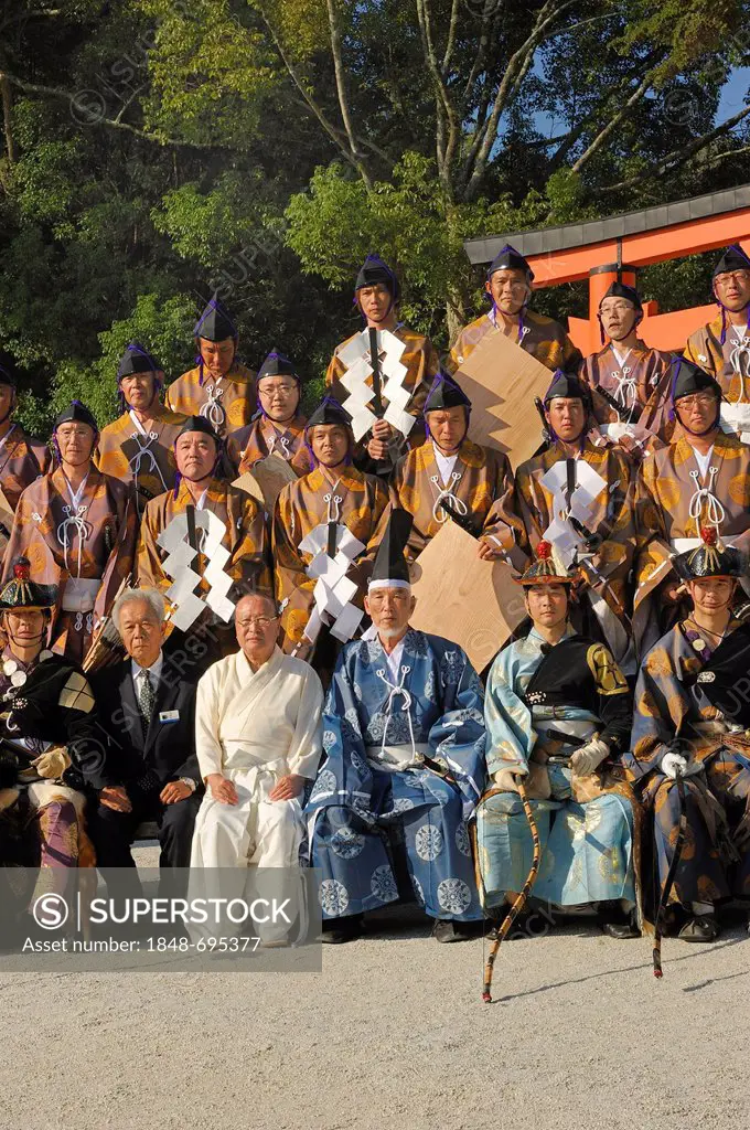 Group picture with all performers involved dressed in clothing from the Heian period, Middle Ages, during a ritual Shinto equestrian competition, Kami...