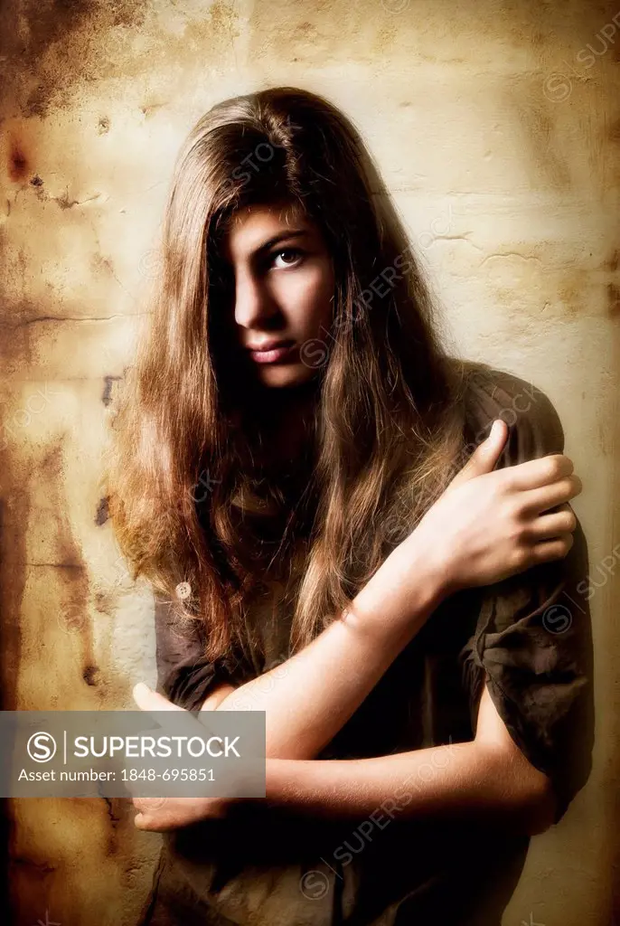 Pensive girl, aged 13, with long hair, artistic portrait