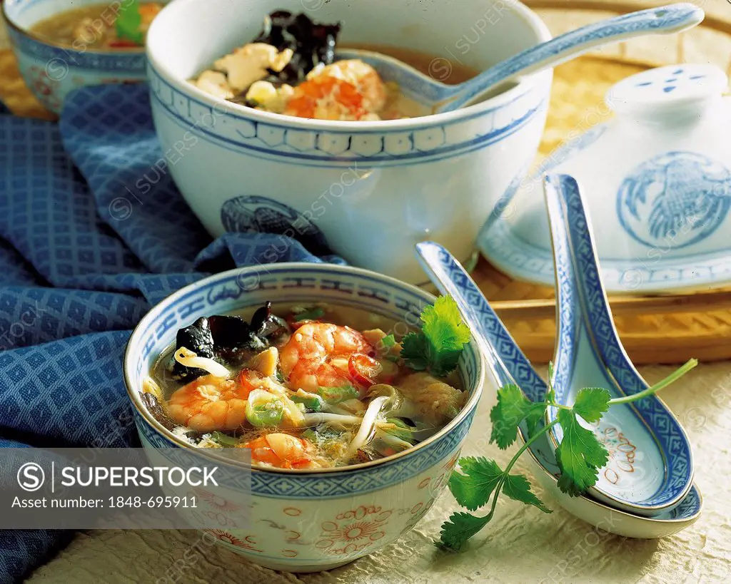 Hot and sour Sichuan-style soup with shrimps, chicken and mushrooms, hearty stew, China
