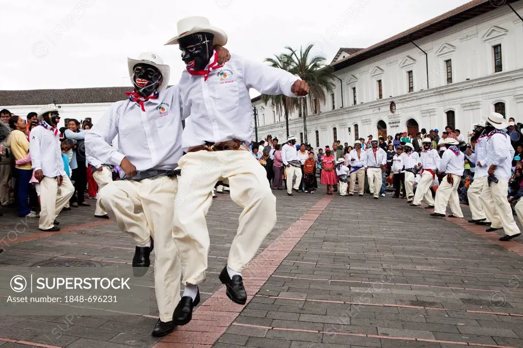 Male dance group on the edge of a procession, car-free Sunday in the historic centre of Quito, Ecuador, South America