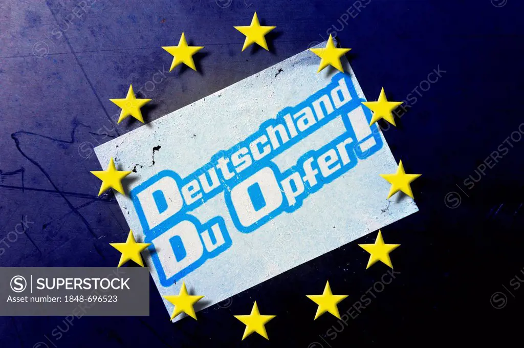 EU stars and sticker on a wall, Deutschland, Du Opfer!, German for Germany, you are a victim