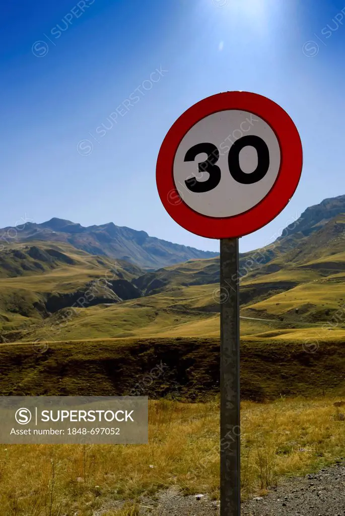 Traffic sign, speed limit 30 km, on the mountain pass road to El Portalet, border ridge between the regions of Aragon and the French department of Hau...