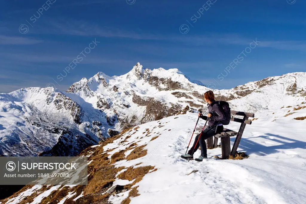 Hiker resting while ascending Penser Weissenhorn Mountain above Penser Joch Pass, looking towards the summit of Penser Weissenhorn Mountain, Sarn Vall...