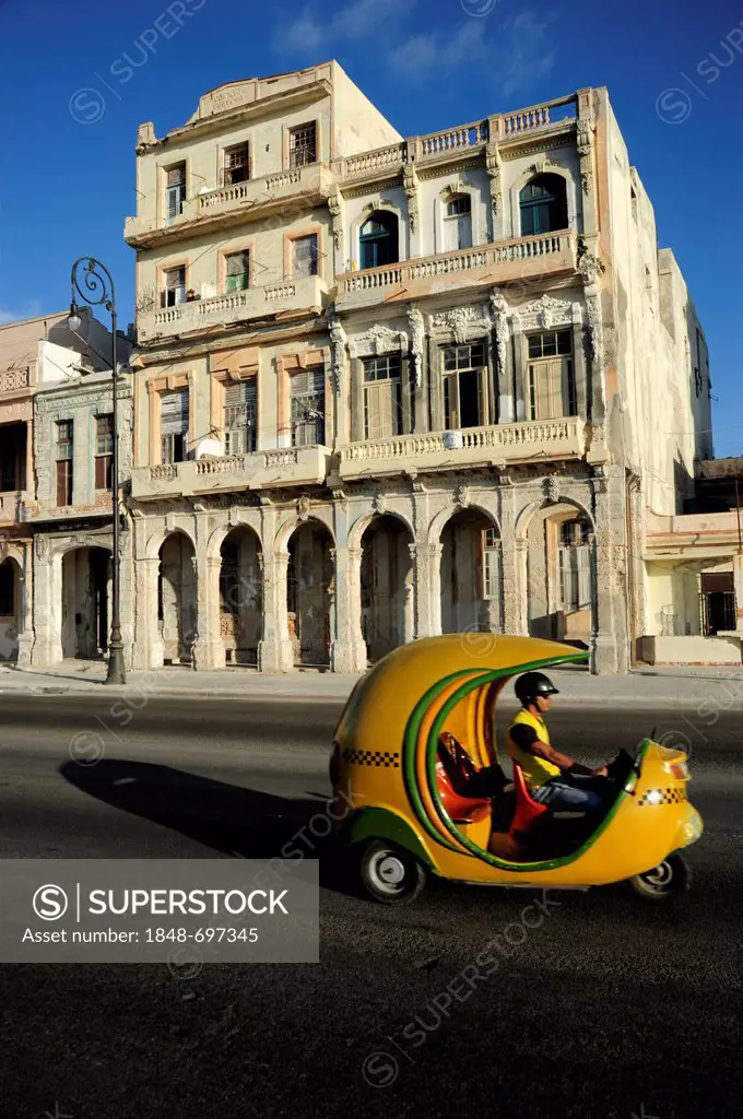 Coco Taxi, a roofed motor scooter at the Malecon, Avenida de Antonio Maceo, a boulevard along the city centre of Havana, Centro Habana, Cuba, Greater ...