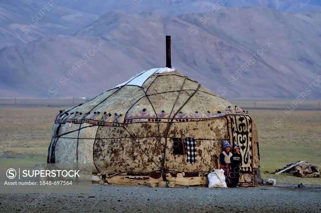 Two Kirghiz children in front of a yurt in the high plateau, Pamir region, Tajikistan, Central Asia, Asia