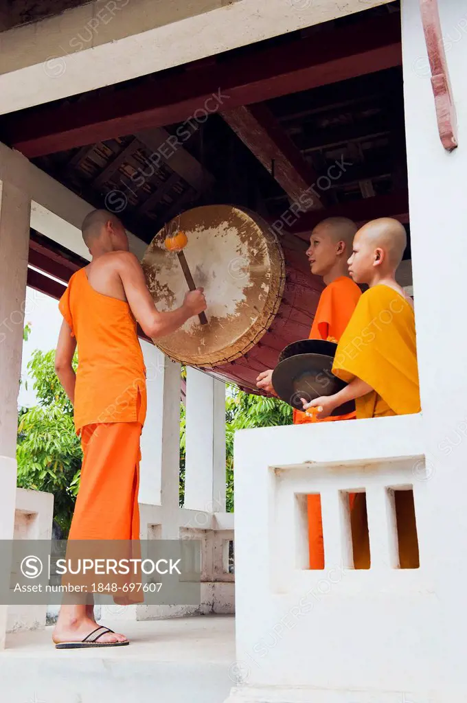 Monk drumming at the Wat Sop Sickharam Temple, Luang Prabang, UNESCO World Heritage Site, Laos, Indochina, Asia