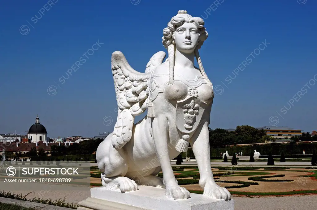Sculpture of a sphinx against a blue sky at the Oberes Schloss Belvedere palace, Unteres Schloss Belvedere palace at the back, Prinz-Eugen-Strasse str...