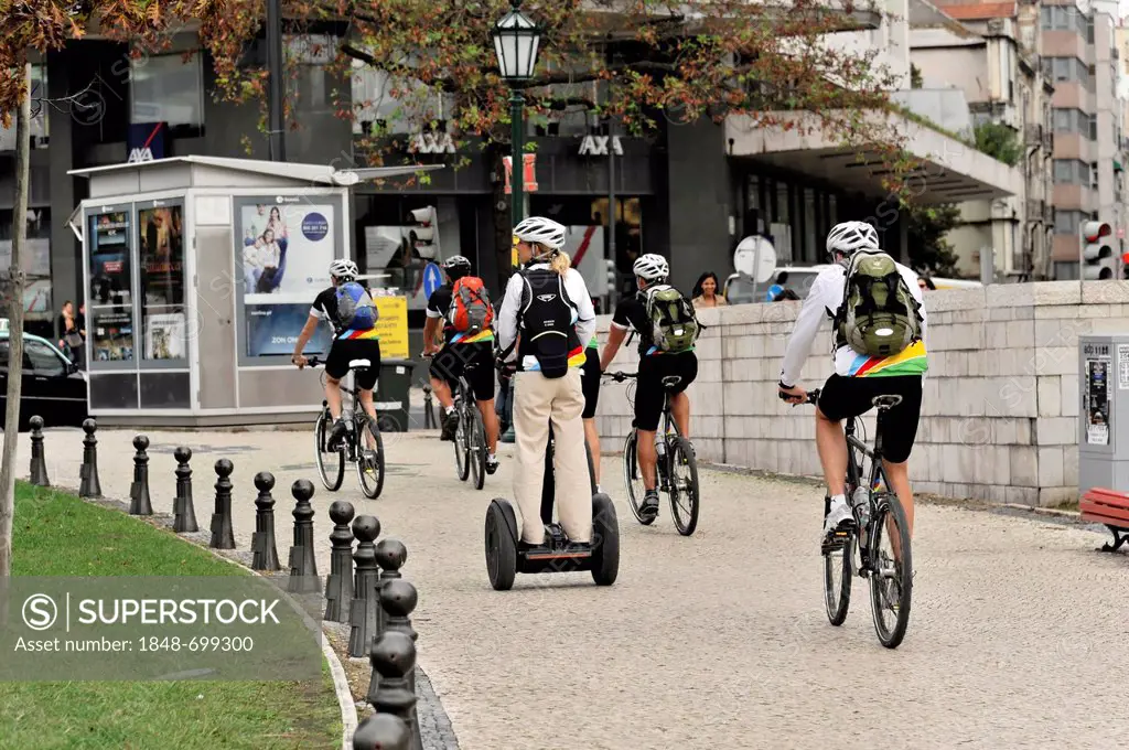 Tourists of a cruise ship riding bicycles and Segways during a shore excursion, Praca Marques de Pombal, Lisbon, Lisboa, Portugal, Europe