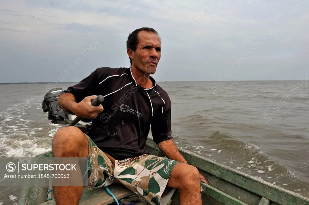 Fisherman in his small boat with an outboard engine in Sepitiba Bay, since the construction of the TKCSA steel plant by Thyssen-Krupp, the fishermen s...