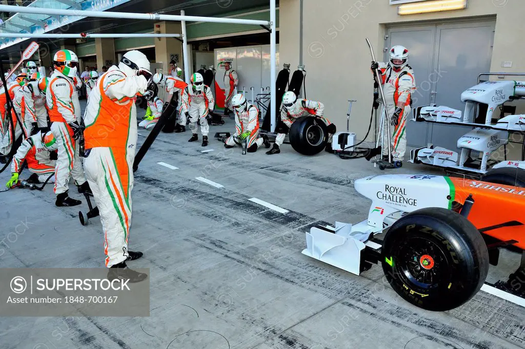 Force India team of technicians testing a tire change in the pit lane of the Yas Marina Circuit on Yas Island during the Grand Prix 2011, Abu Dhabi, U...