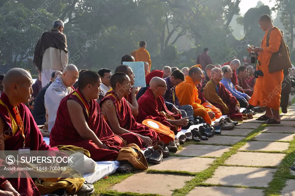 Monks from all Buddhist traditions gather for a communal prayer in their orange and red robes, Global Buddhist Congregation 2011, at Gandhi Smitri, Ne...