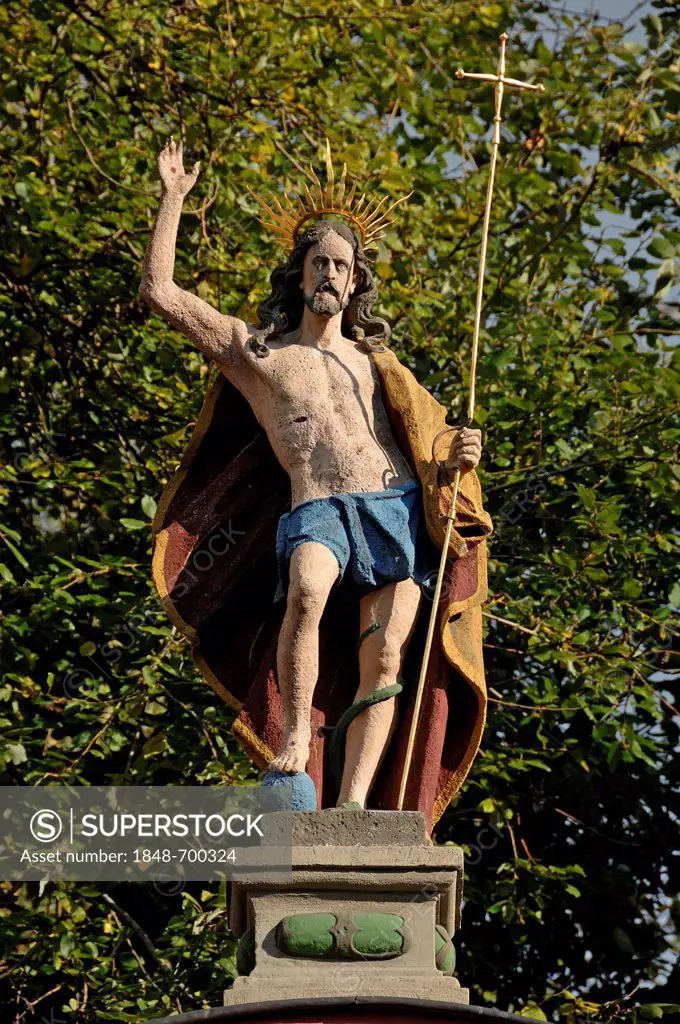 Sculpture of Christ, right hand raised in blessing, holding a crucifix in his left hand, at the entrance to Salvatorkirche Church, Obere Salvatorgasse...