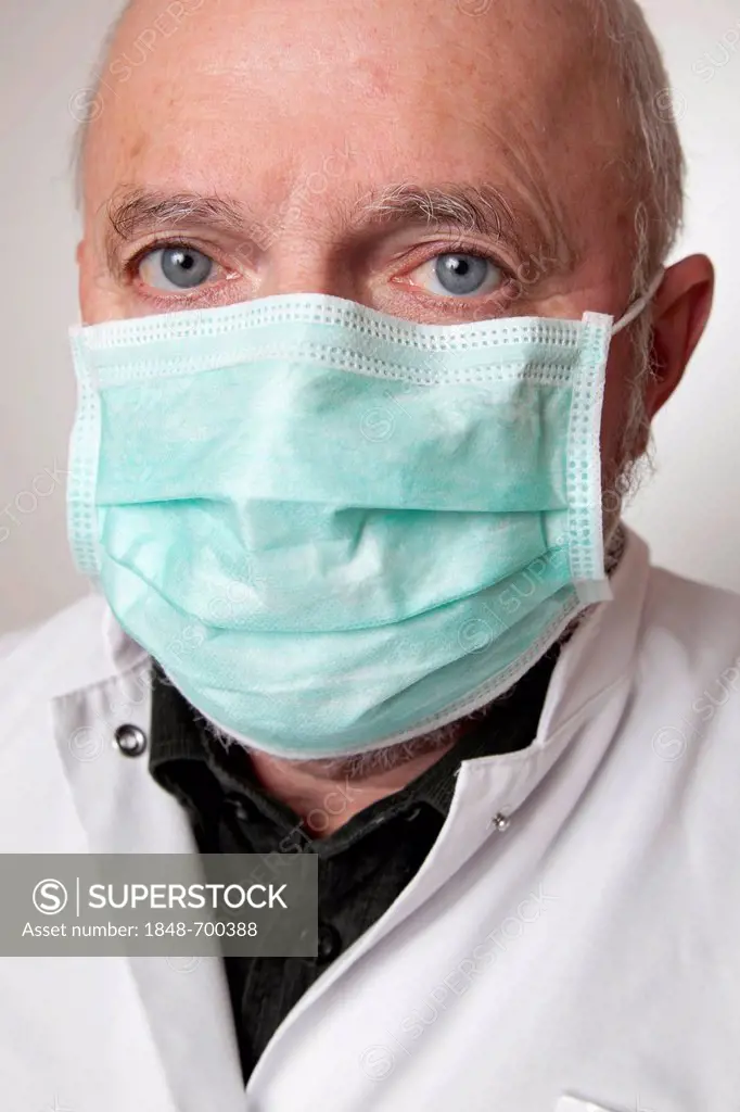 Doctor, physician wearing a white coat and a medical face mask