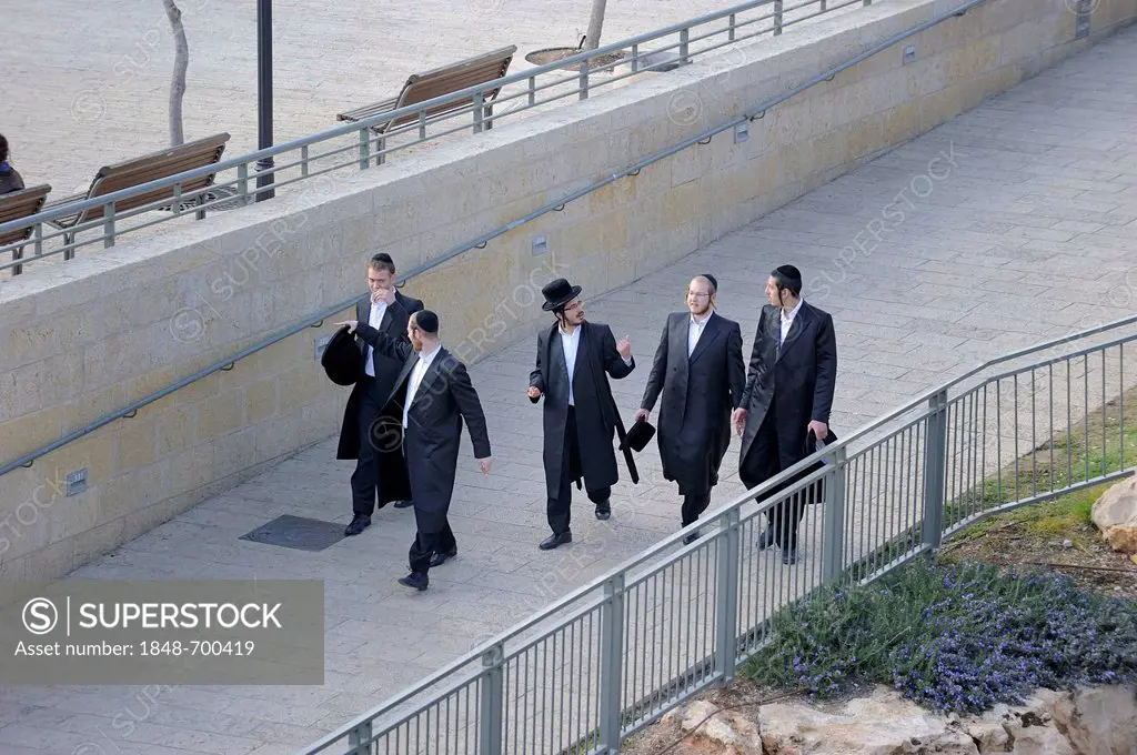 Orthodox Jews walking to Sabbath prayer toward the Western Wall or Wailing Wall, Old City of Jerusalem, Israel, Middle East