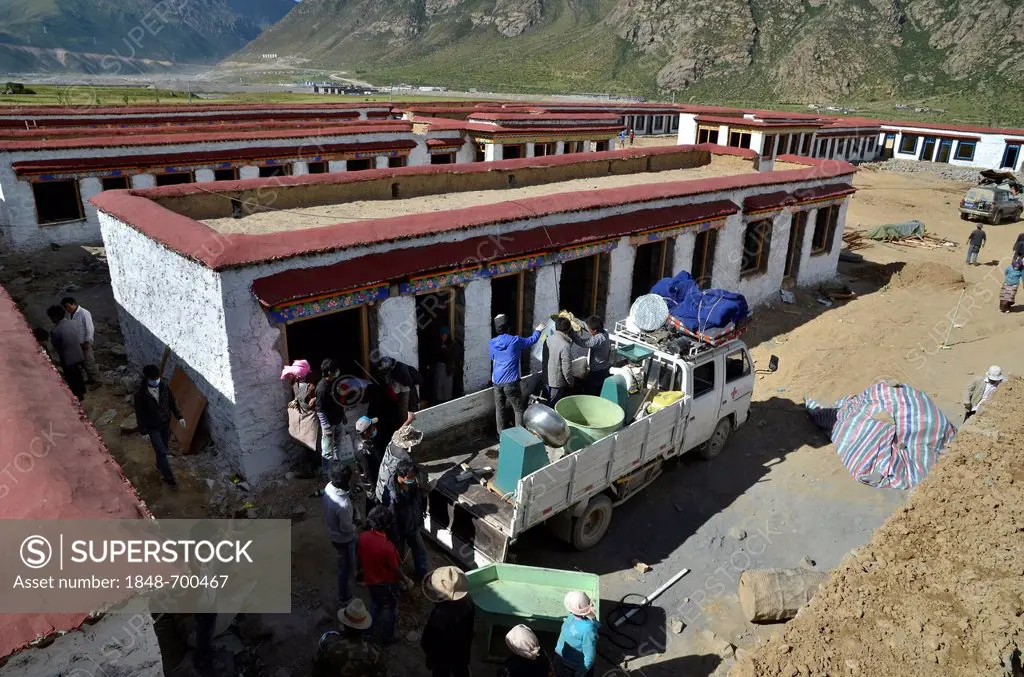 Tibetan craftsmen with truck during the construction of a traditional Tibetan building, Pundo, Reting, Himalayas, Lhundrup County, central Tibet, Tibe...