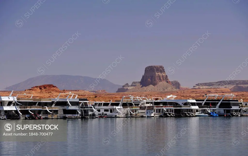 House boats are moored in the harbour of Antelope Point Marina with Tower Butte at back, Lake Powell, Wahweap Marina, Glen Canyon National Recreation ...