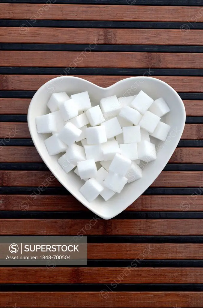Sugar cubes in a heart-shaped porcelain bowl