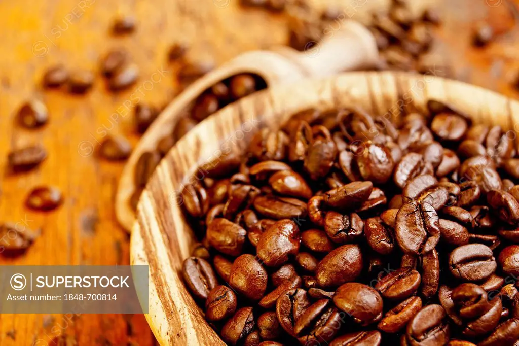 Wooden bowl with roasted coffee beans