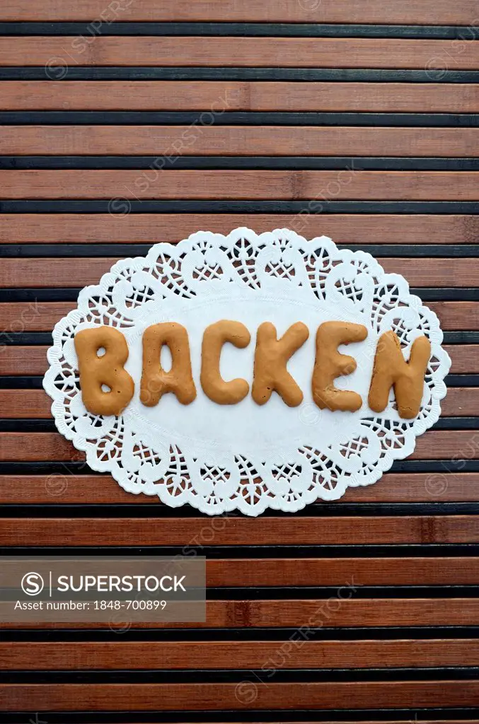 Backen, German for baking, written with alphabet biscuits on a paper doily