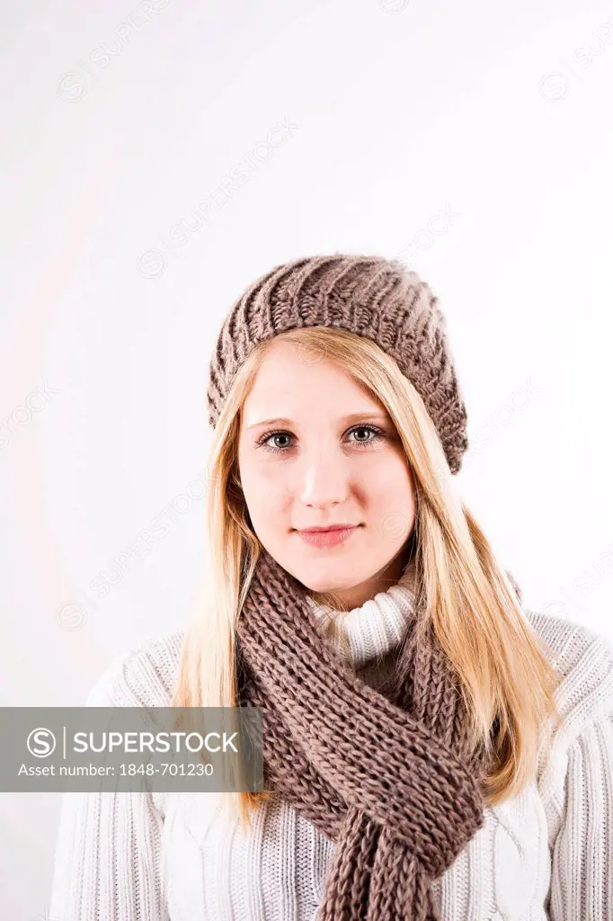 Smiling young woman wearing a hat and scarf, portrait