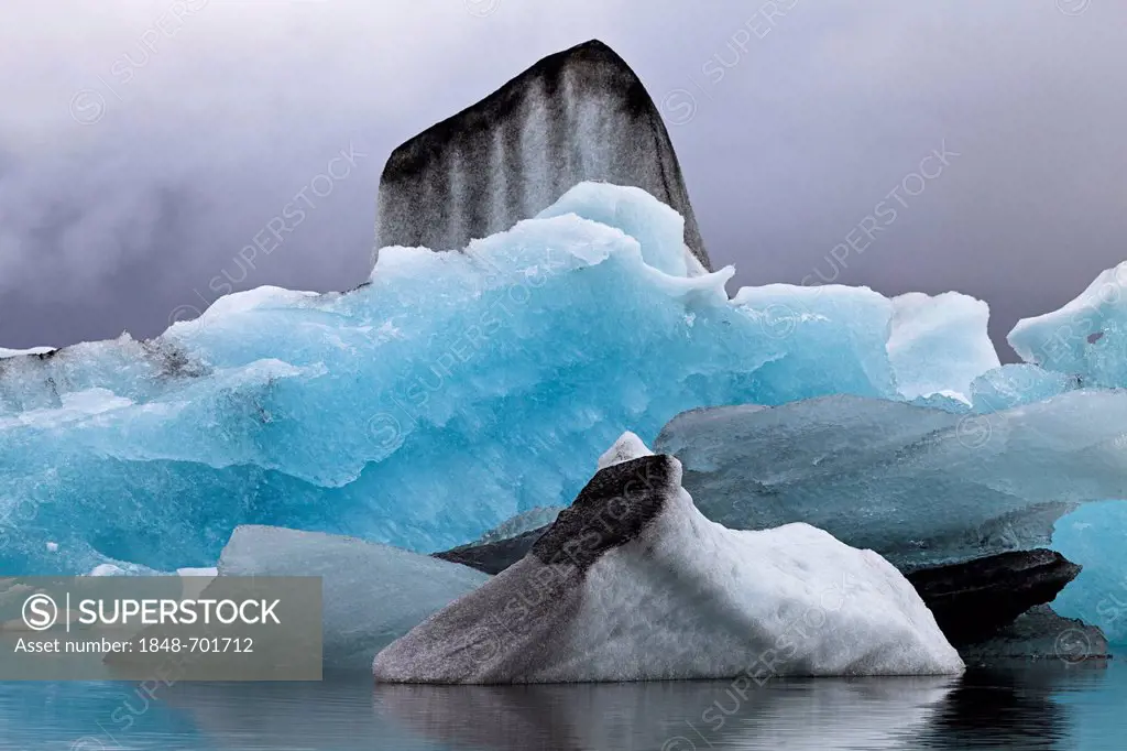 Small icebergs with traces of volcanic ash in the Joekulsarlon glacial lagoon of the Vatnajoekull Glacier, Iceland, Europe