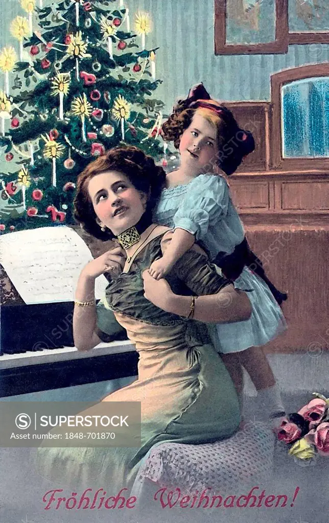 Woman and child sitting in front of the Christmas tree, piano, Christmas, Froehliche Weihnachten in writing, German for 'Merry Christmas', historic il...