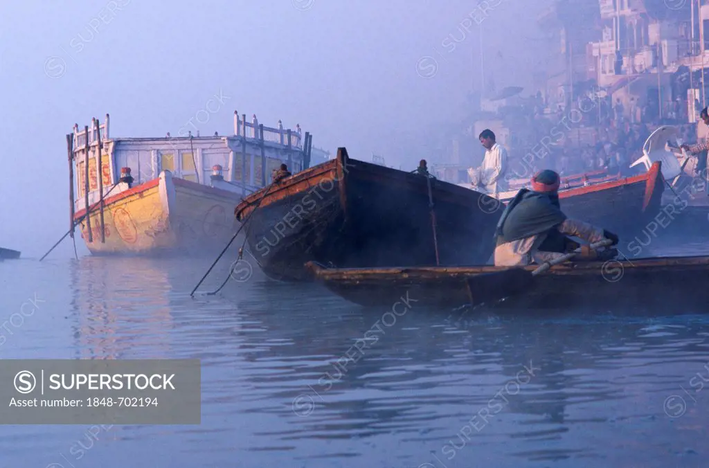 Boats on river Ganges, waiting to take pilgrims for a ride on the holy river, Varanasi, Uttar Pradesh, India, Asia