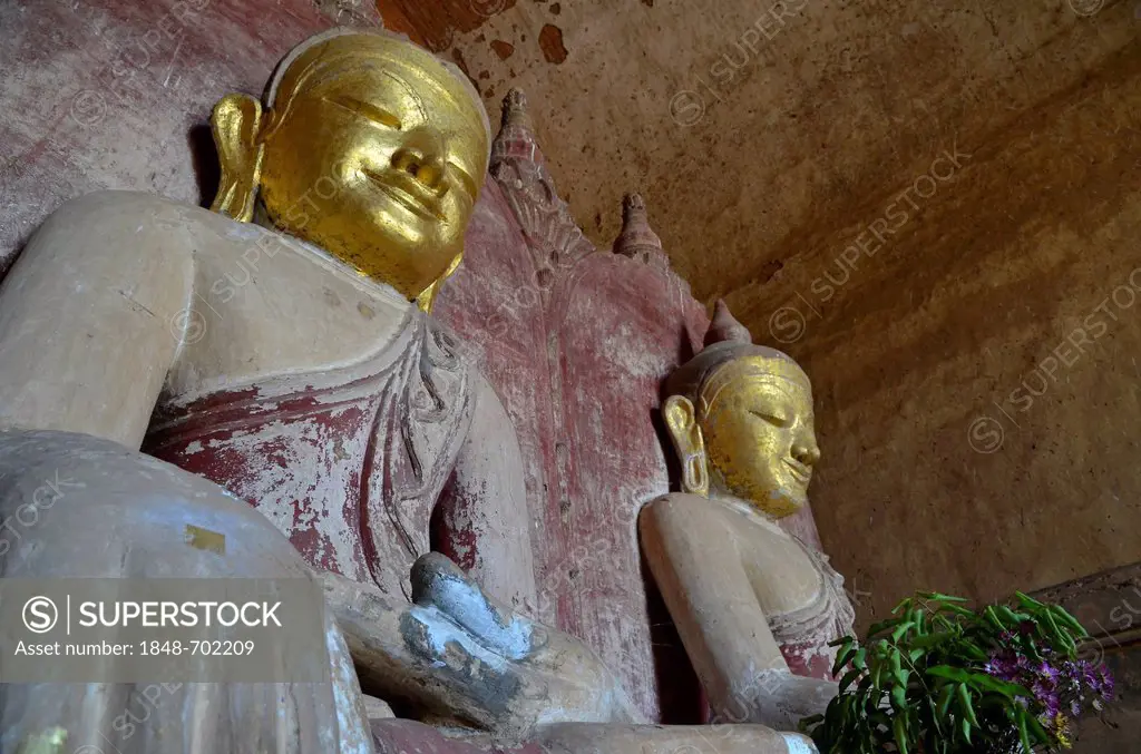 Buddhism, two gilded seated Buddha figures in the pagoda of Htilominlo Temple from the 13th Century, one of the last great temples built before the fa...