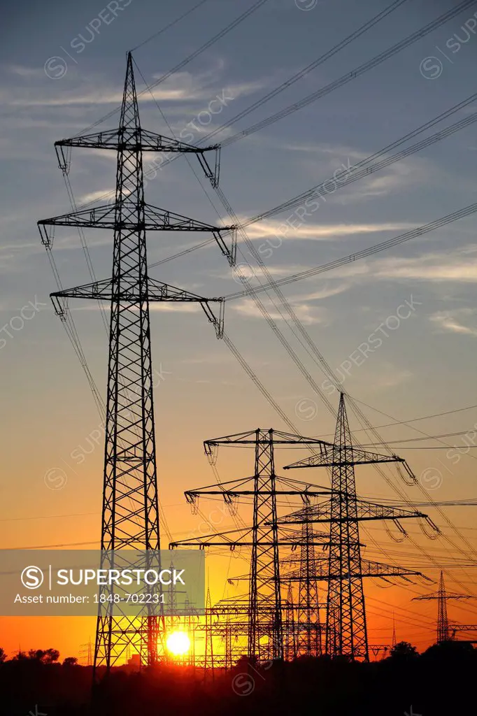 Electricity pylons, power lines, sunset in Karnap quarter, Essen, North Rhine-Westphalia, Germany, Europe