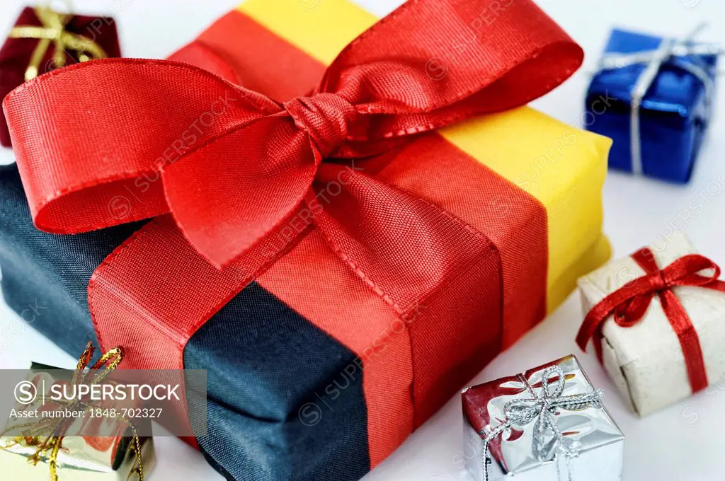 Present wrapped in the German national colours, symbolic image for tax cuts, tax gift