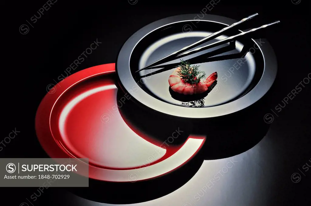 Plates with chopsticks and a prawn