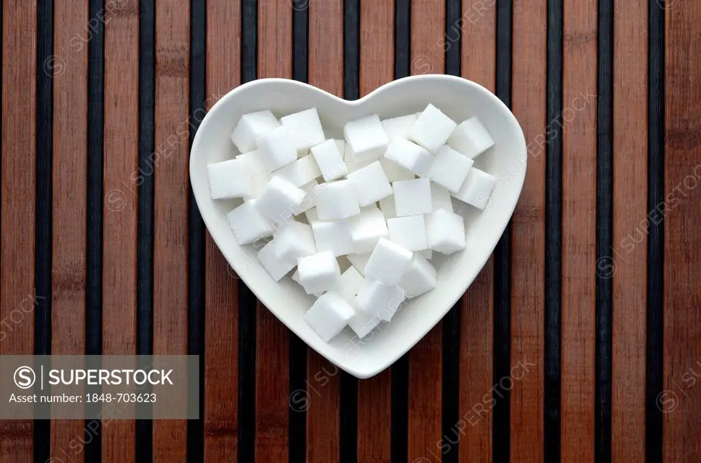 Sugar cubes in a heart-shaped porcelain bowl