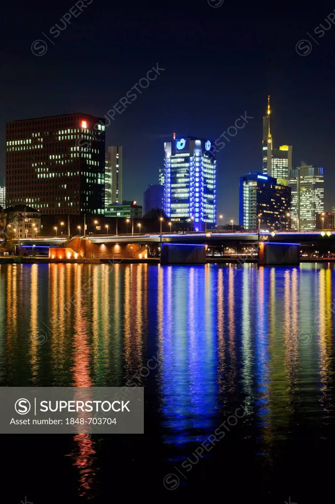 View of the Frankfurt skyline with blue-lit Union Investment building, the yellow-lit Commerzbank tower, IG Metall headquarters, life at front, and Fr...