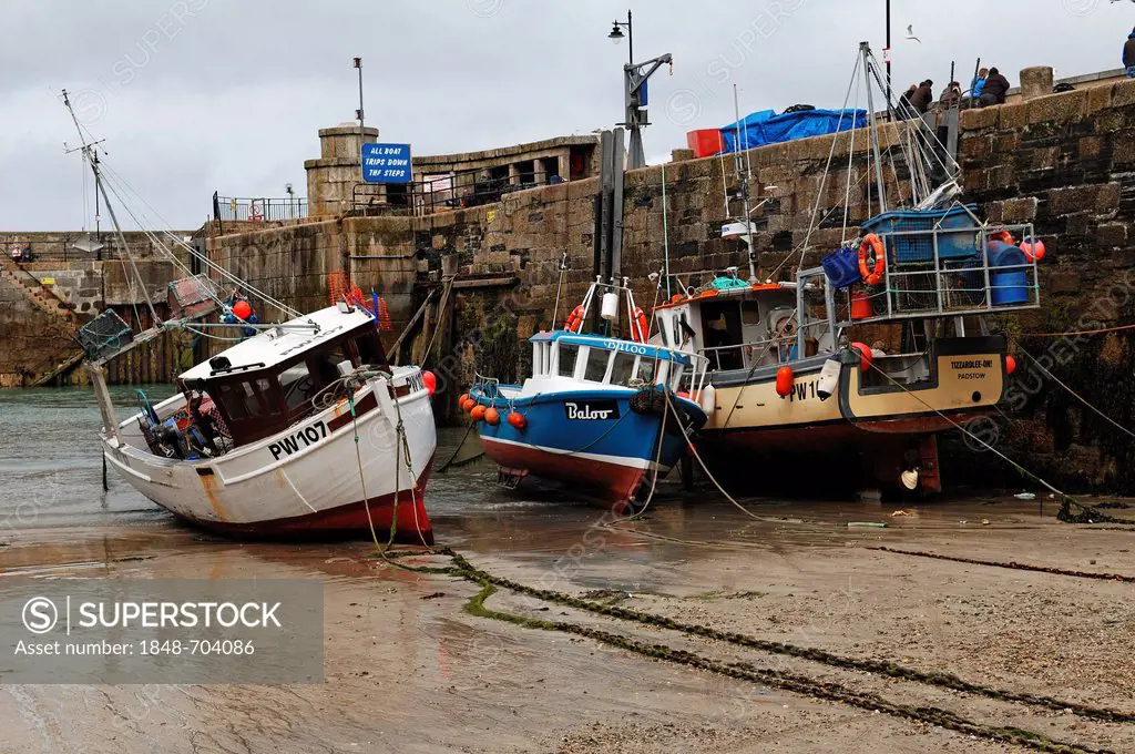 Fishing boats at low tide at the port of Newquay, Cornwall, England, United Kingdom, Europe