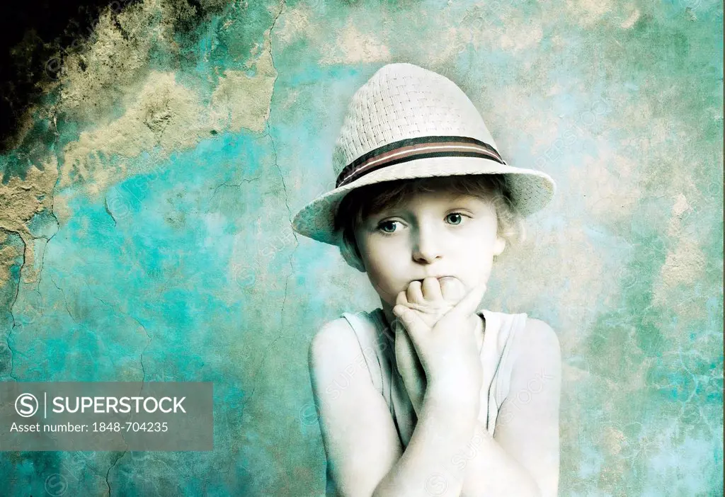 Five-year-old boy wearing a hat, sad face, portrait