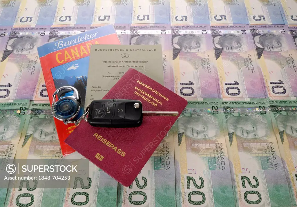 Ignition key, international driving license, passport of the Federal Republic of Germany, guide book for Canada and various Canadian dollar banknotes
