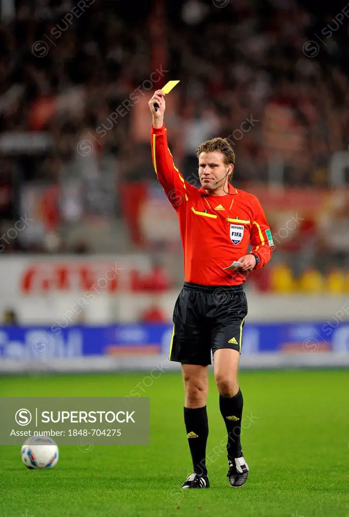 Referee Dr. Felix Brych, showing yellow card, 1. FC Koeln, warning, Mercedes-Benz Arena, Stuttgart, Baden-Wuerttemberg, Germany, Europe