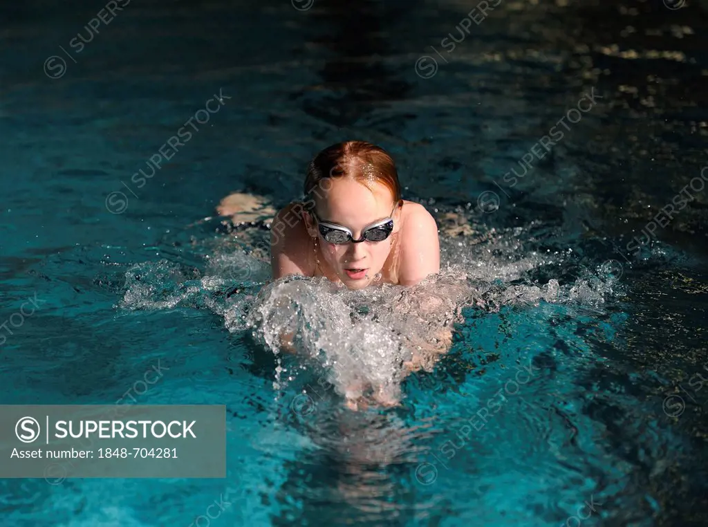 Boy, swimmer, 12 or 13 years, swimming in a swimming pool