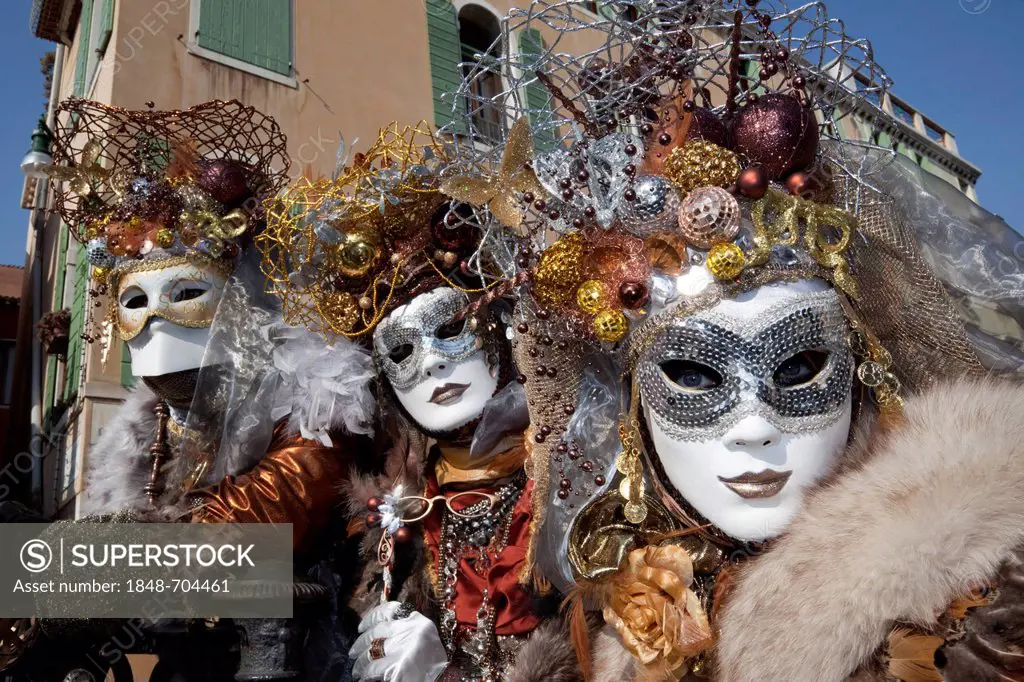 Masked group with Christmas decorations on their heads at the carnival in Venice, Veneto, Italy, Europe