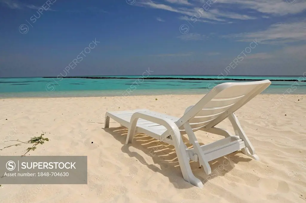 White sun lounger on a white sandy beach, Maldvies, Indian Ocean