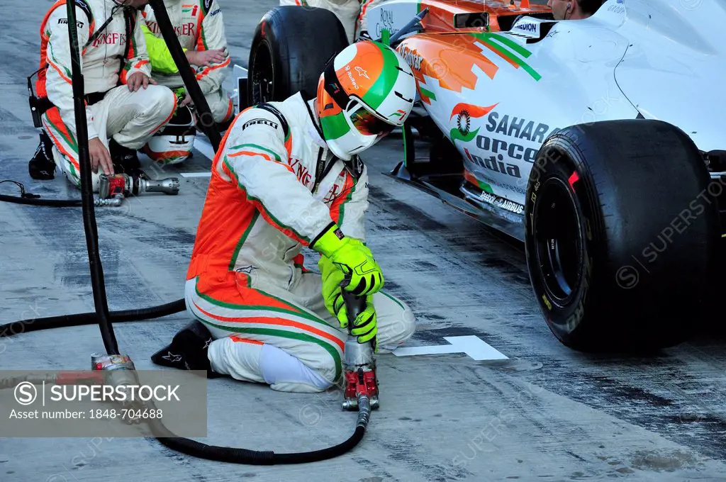Force India team of technicians testing a tire change in the pit lane of the Yas Marina Circuit on Yas Island during the Grand Prix 2011, Abu Dhabi, U...