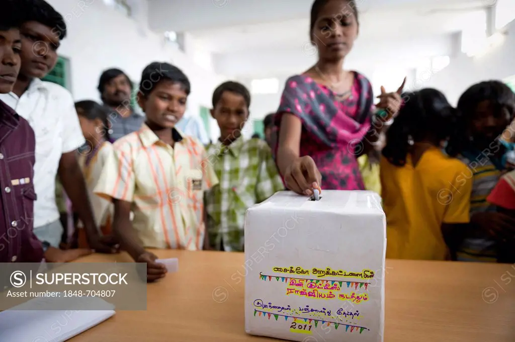 Girl putting ballot into voting box, mini Kutties Rajiyam, panchayat election, Noyyal Maravapalayam near Karur, Tamil Nadu, South India, Asia