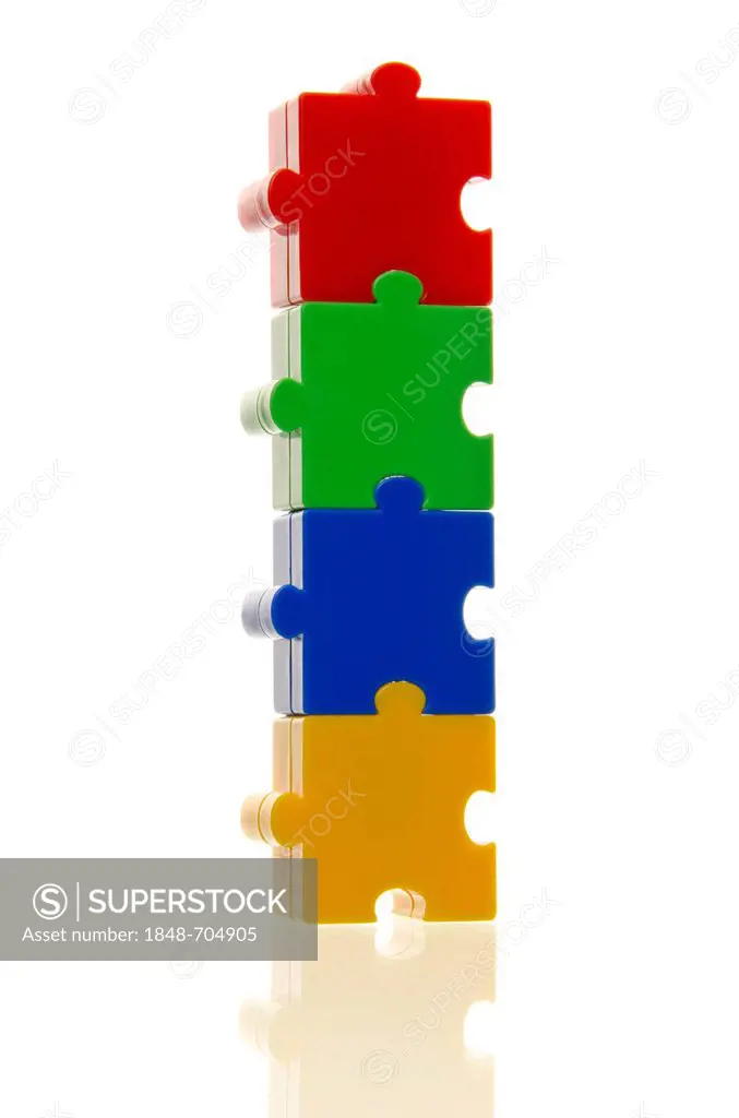 Four colourful puzzle pieces stuck on top of each other, connected, symbolic image for cohesion