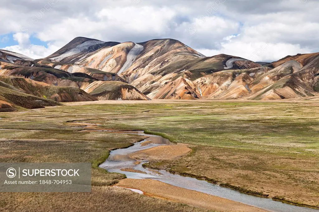 Valley with a stream in the colourful rhyolite mountains of Landmannalaugar, Fjallabak Nature Reserve, Iceland, Europe
