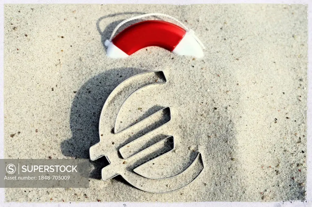 Euro symbol lying on a beach next to a lifebuoy, symbolic image for euro crisis