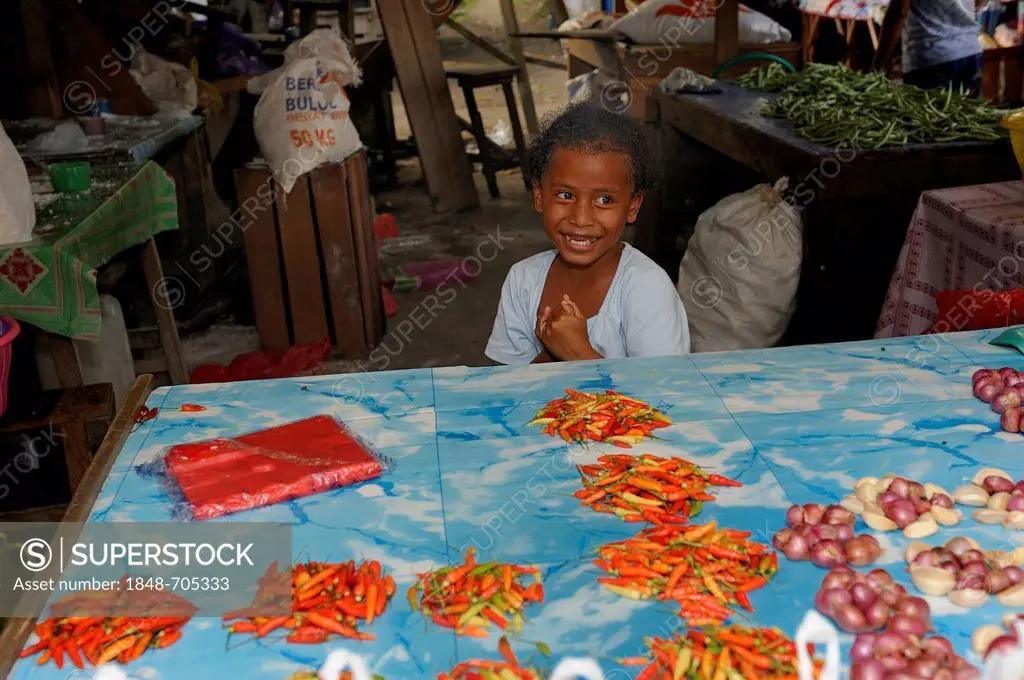 Little Papuan girl selling chili peppers and onions at the market, Kota Biak, Biak Island, Irian Jaya, Indonesia, Southeast Asia, Asia