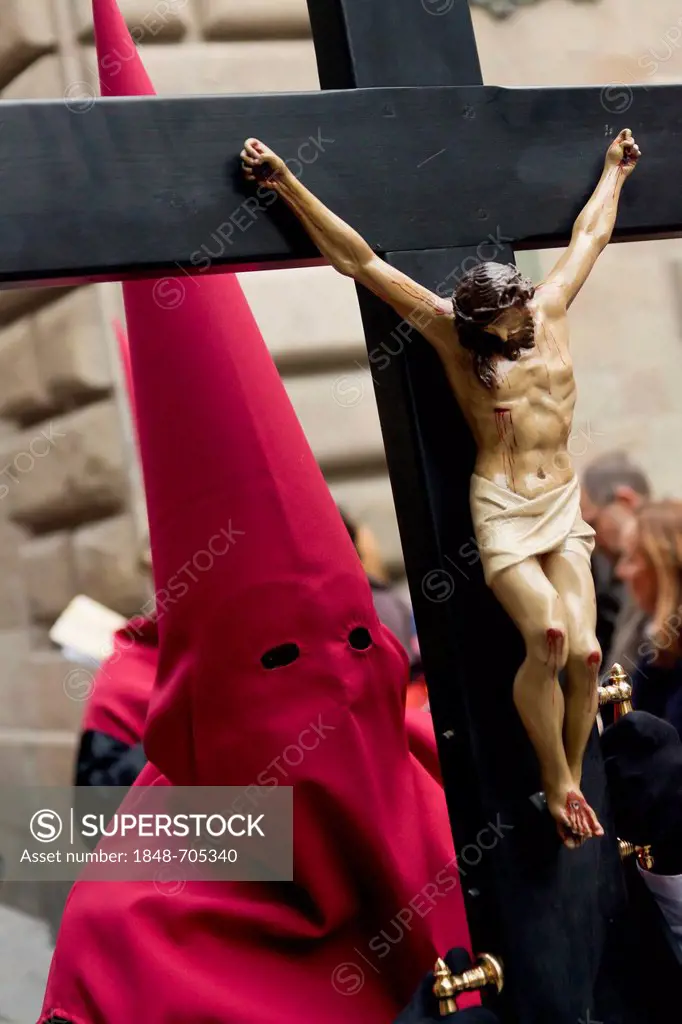 Penitent with a cross at the Good Friday procession, Semana Santa, Holy Week, Barcelona, Catalonia, Spain, Europe