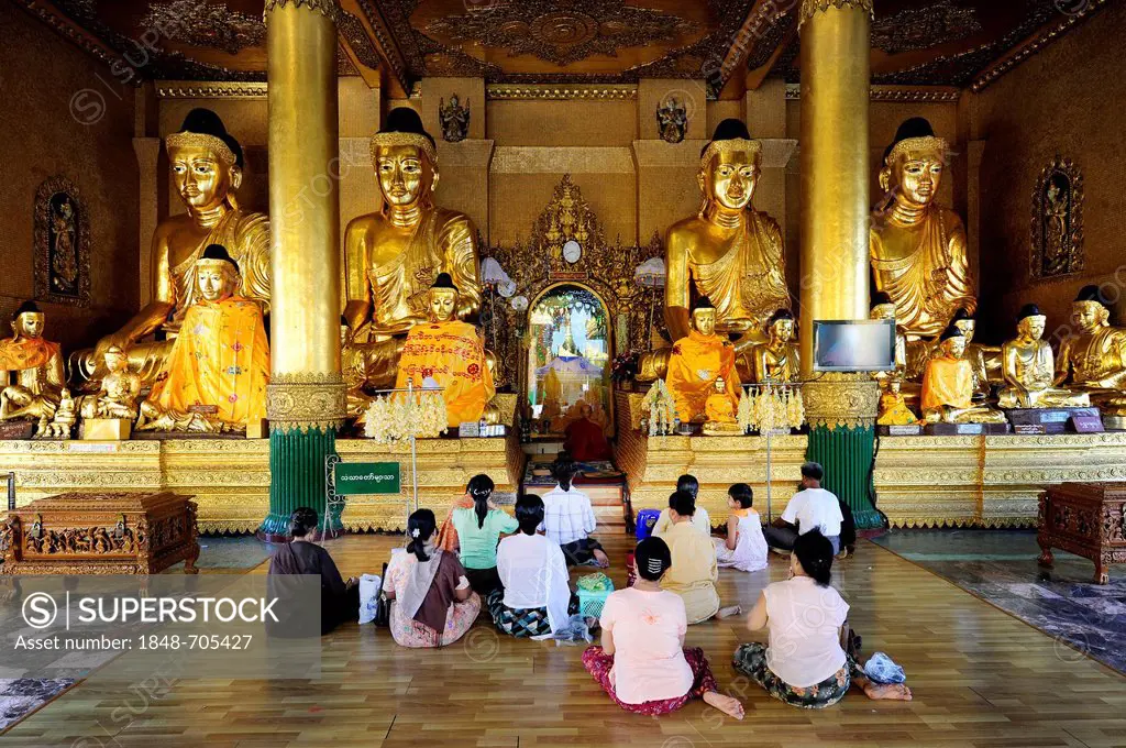 Buddhists praying at the Shwedagon Pagoda, Yangon, Burma also known as Myanmar, Southeast Asia, Asia