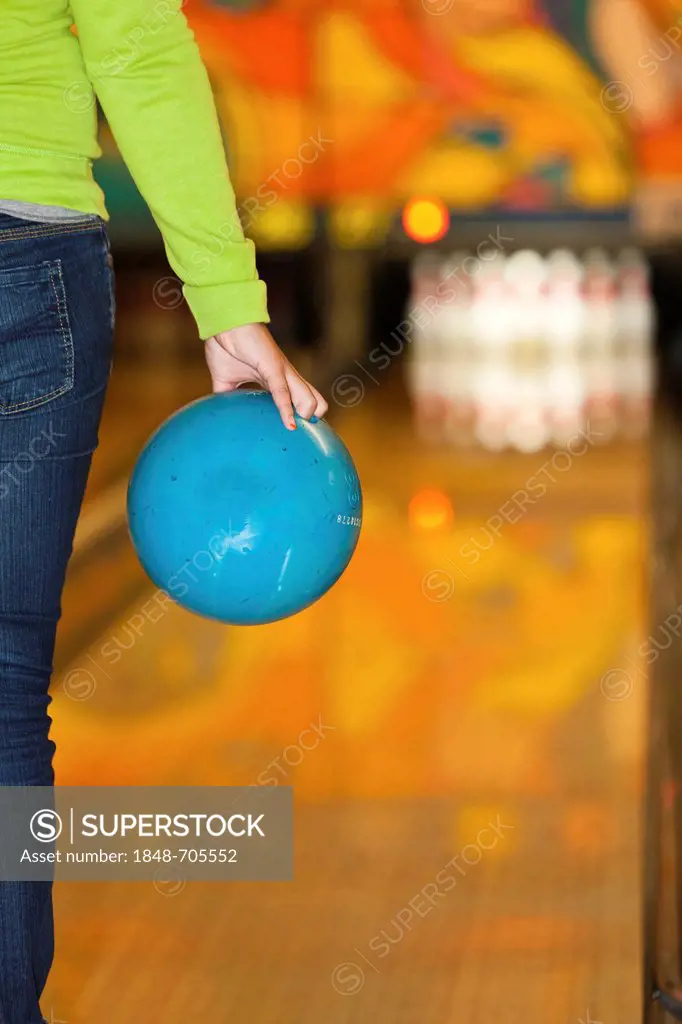 Bowling player about to bowl a bowling ball, bowling centre, Germany, Europe
